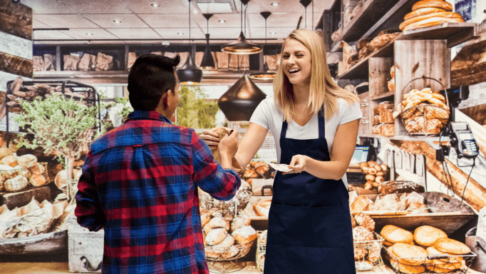 Bakery owner serving customer