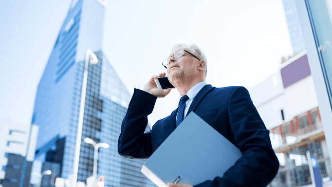 Older gentleman walking and talking on phone